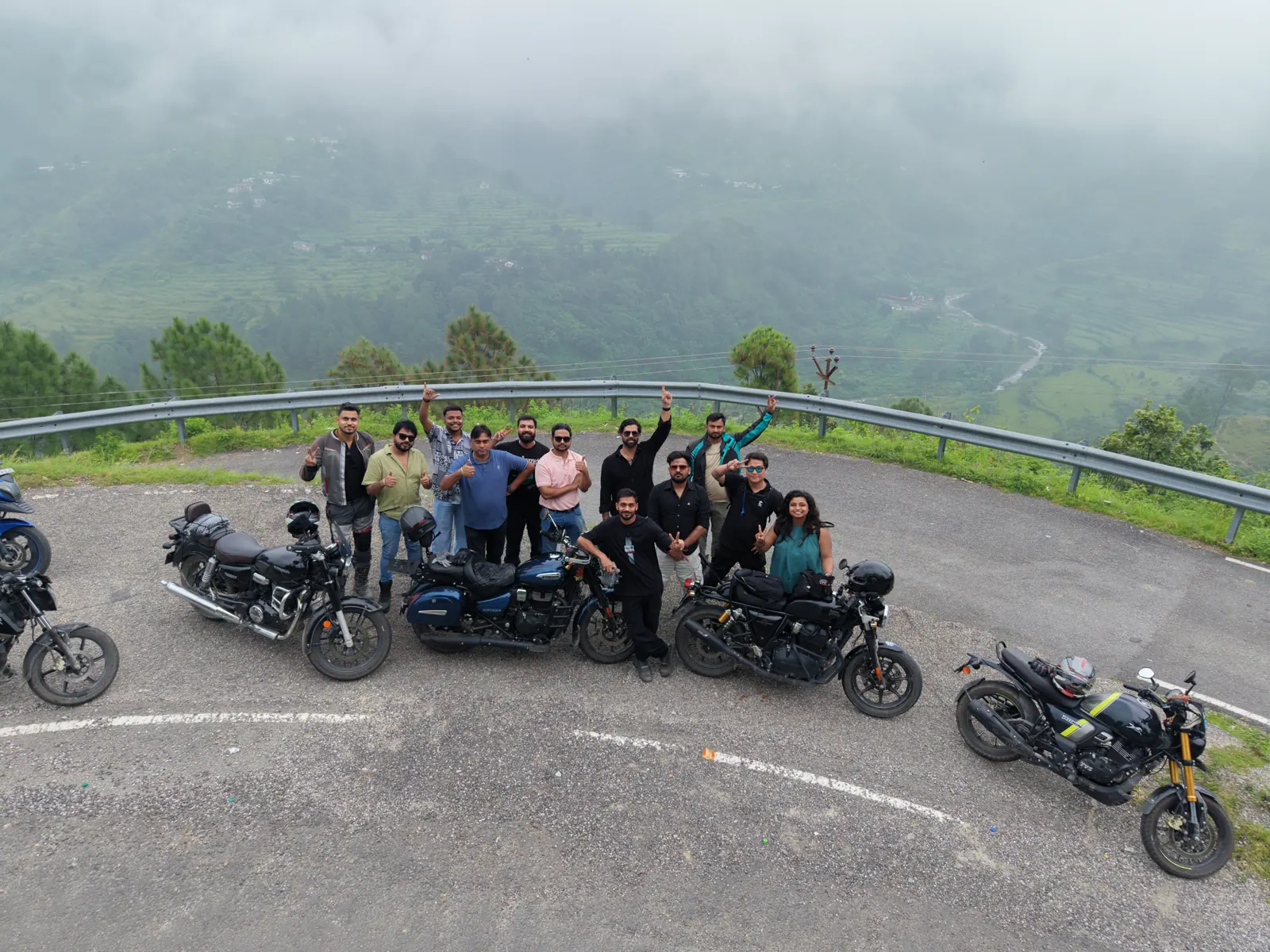 Drone shot of OROI riders at a misty hairpin near Lansdowne